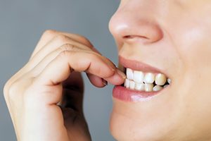 Woman Biting Her Nails