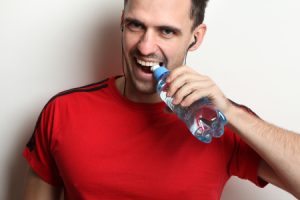 Man Opens Bottle Water with Teeth