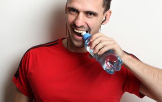 Man Opens Bottle Water with Teeth