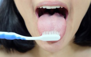 Woman Brushing Her Tongue